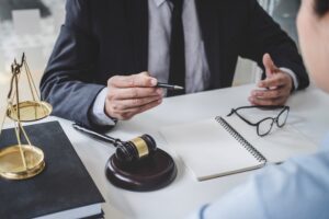 A solicitor sitting behind a desk answers the question, "Can I be sacked for having an accident at work?"